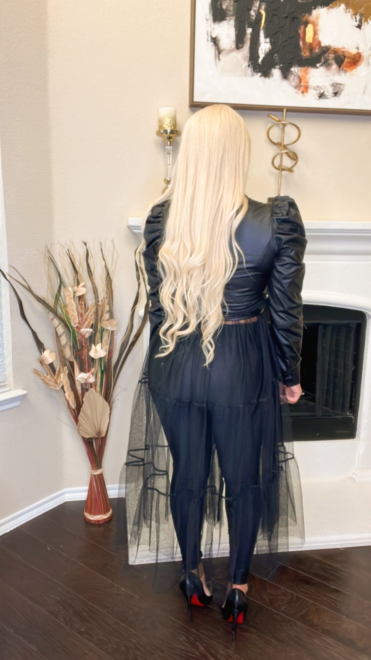 Back view of a women wearing Puffer Leather Mesh Bottom Dress Black by Keeping It Posh